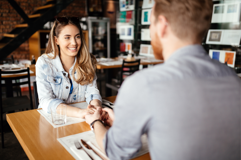 Couple holding hands at a restaurant