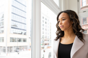 Adult looking out window who experienced childhood trauma