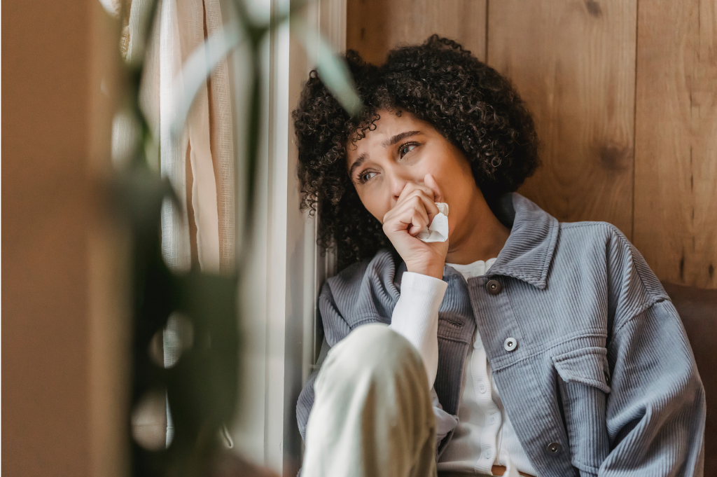A woman sitting and crying