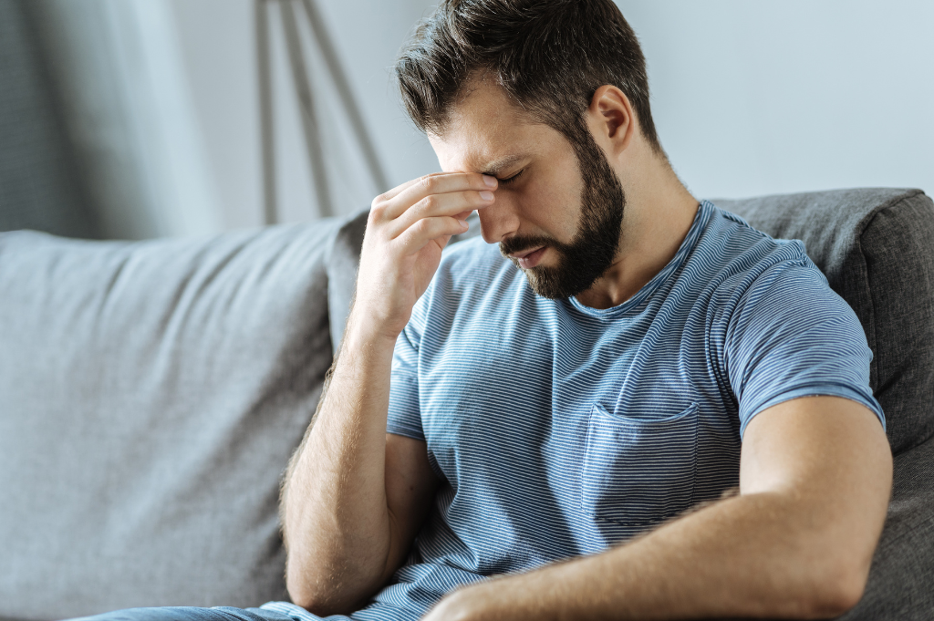 A man holding his forehead