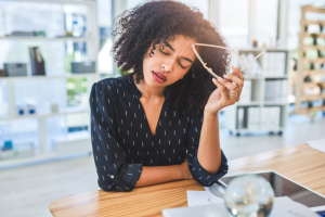 Women sitting at her desk feeling overwhelmed