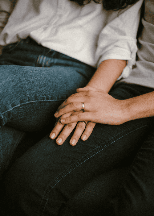 Man and woman in a couples therapy session holding hands