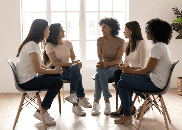Women smiling in a women's group therapy session