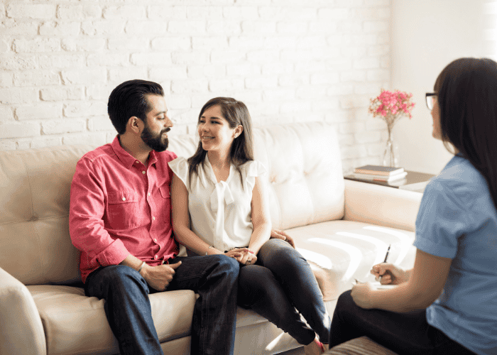 Couple looking happy in a therapy session after couples therapy retreat