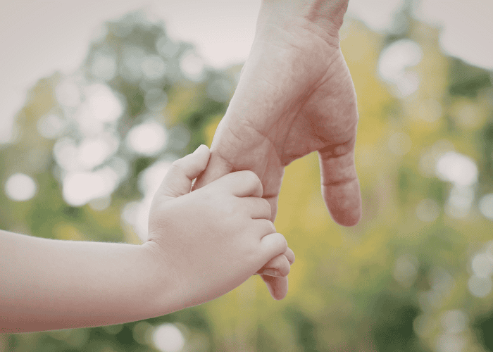 Child holding parent's hand after child therapy sessions