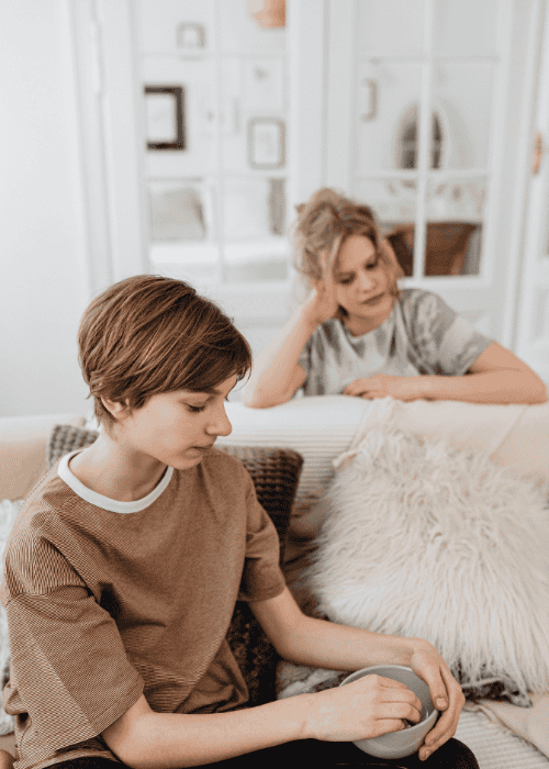 Two teenagers looking unhappy needing teen therapy