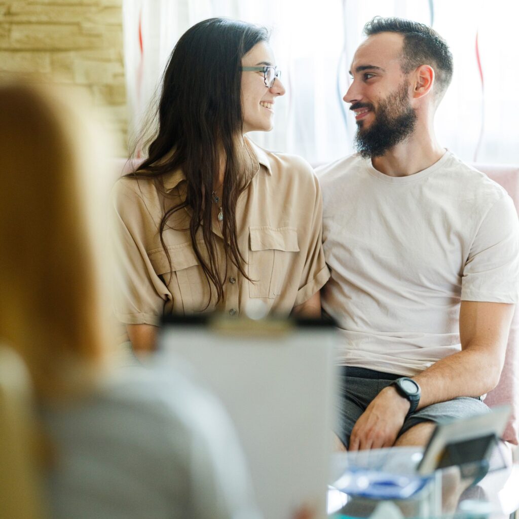 Couple looking happy in a therapy session image