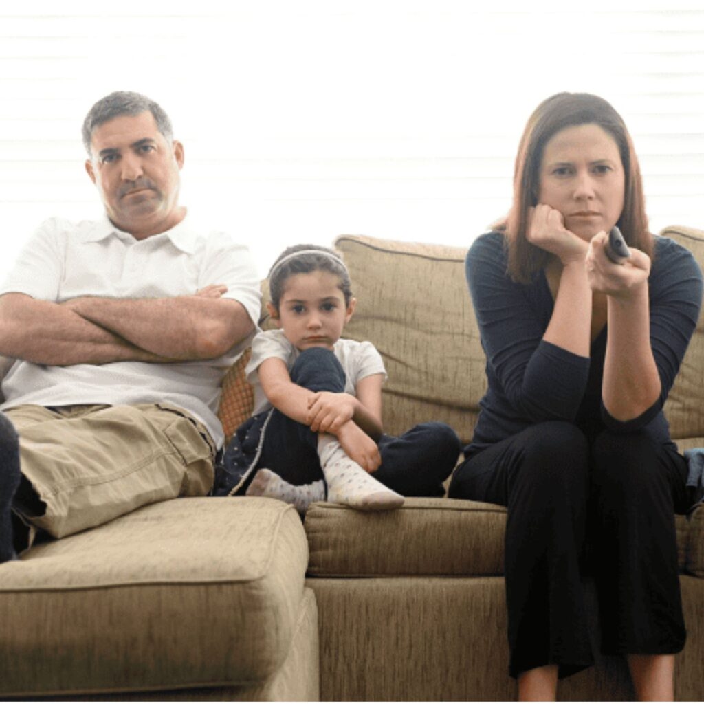 Family looking unhappy watching the TV before family therapy