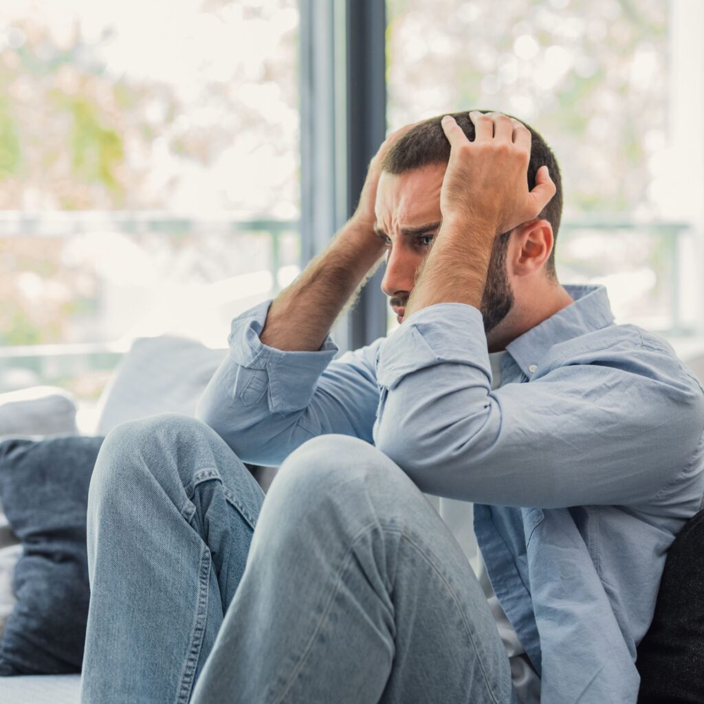 Man confused and struggling from trauma, in need of trauma-informed therapy
